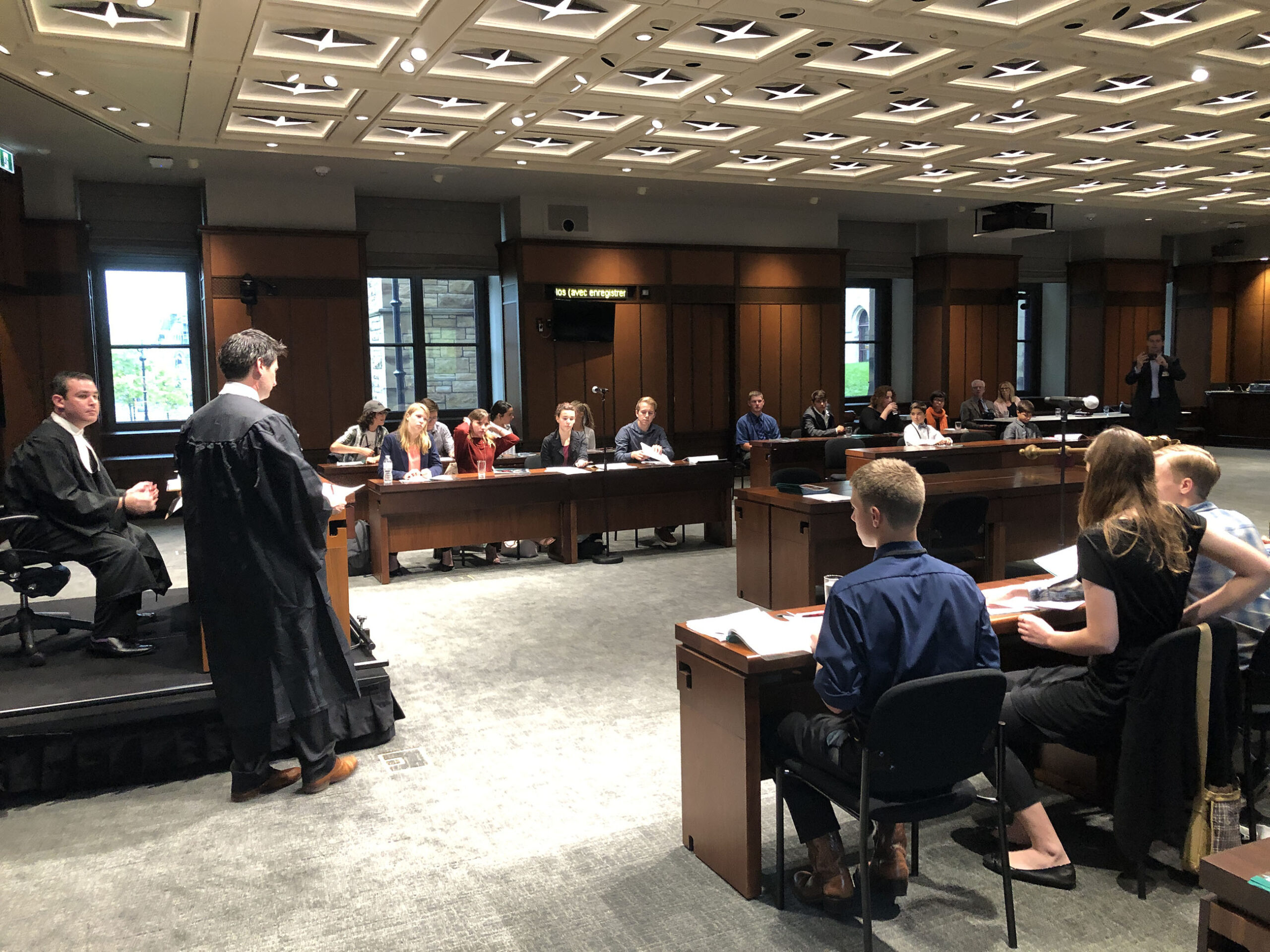 Courtroom with lawyer addressing panel