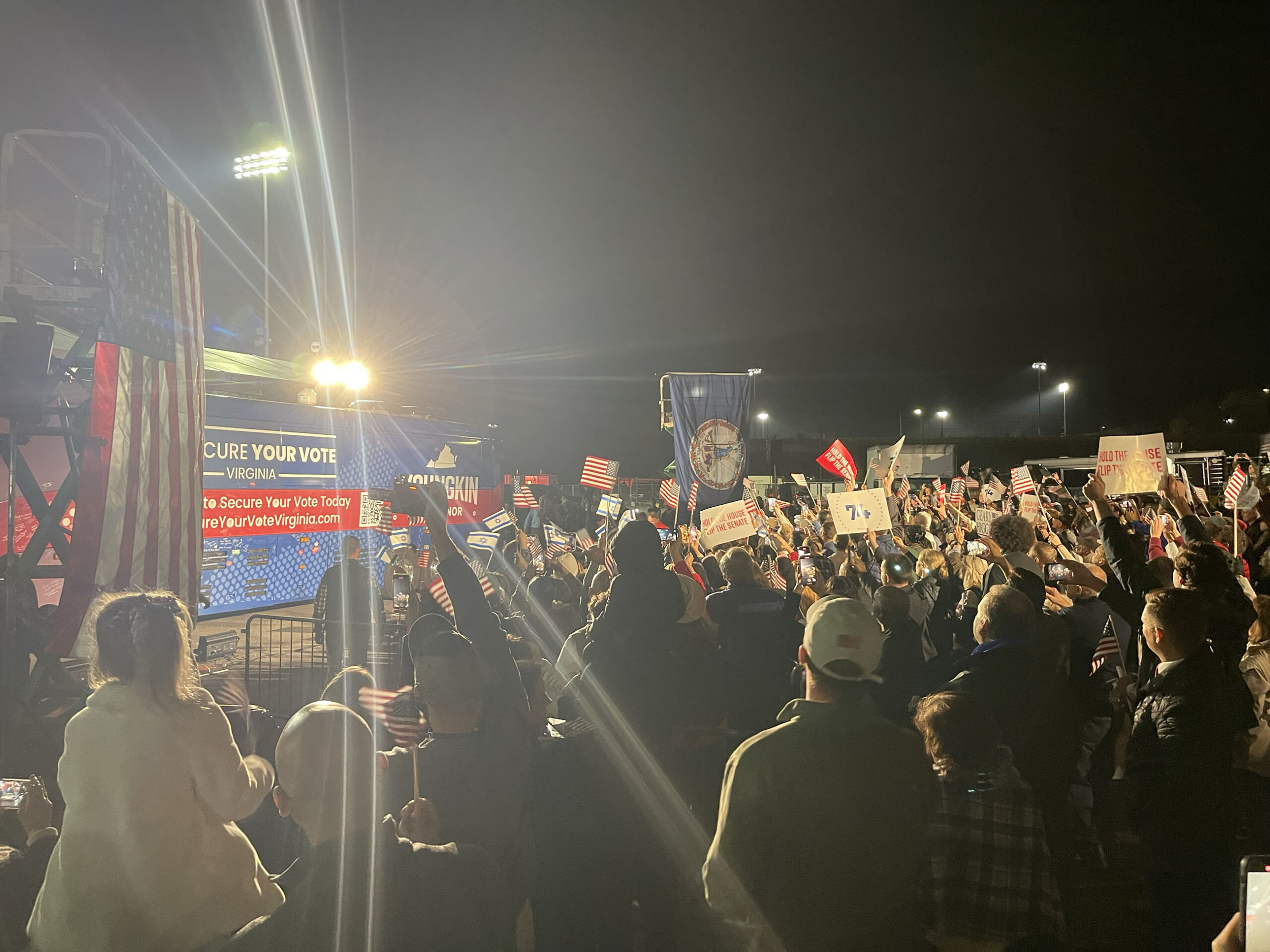 Night campaign rally with signs and lights