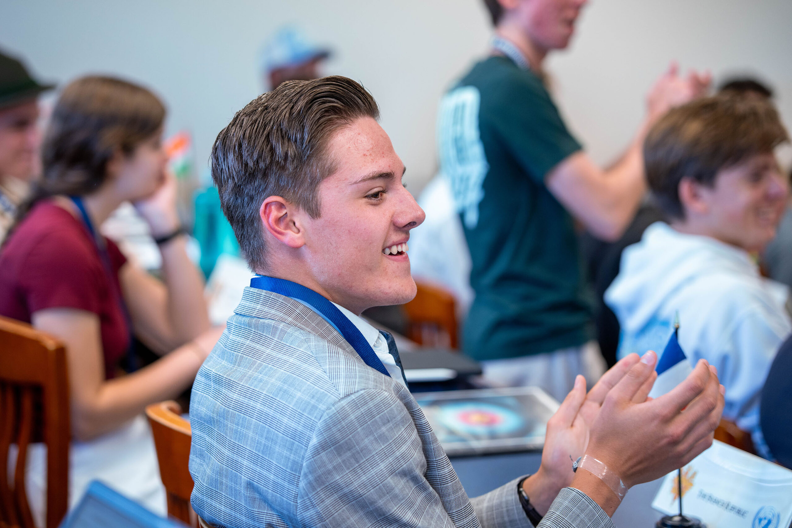Student clapping at indoor event