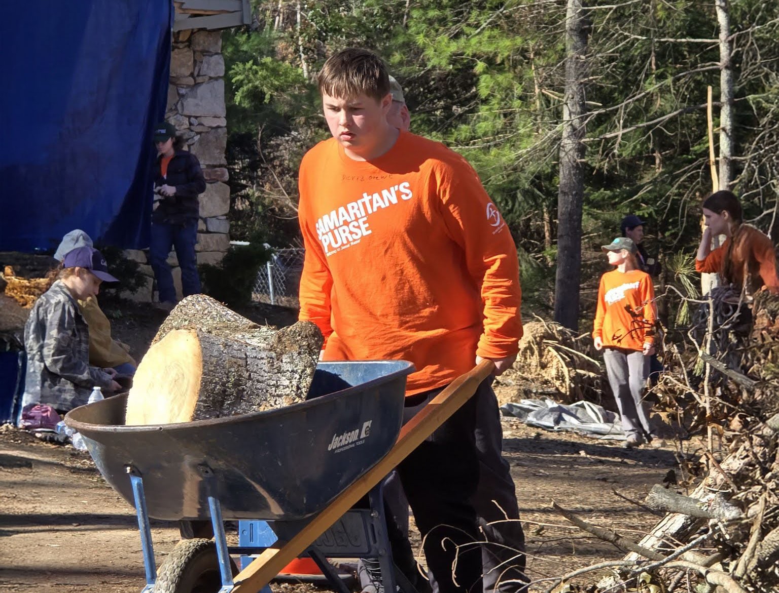 Volunteer-with-wheelbarrow-outdoors-helping
